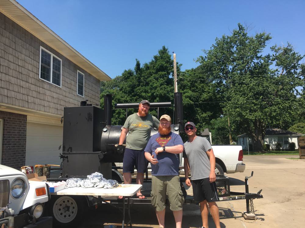 Michael and Lee Quessenberry with a friend in front of the competition rig